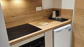 Een koelkast, een oven, een kookplaat, een koffiezetapparaat/waterkoker