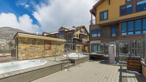 A spa area with hot tubs and a stone wall with a sign. - S2736-0 (Keystone)