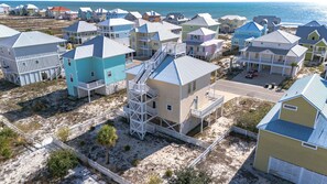 A coastal residential area with multiple two-story houses, some with balconies and a few with external staircases. - Vitamin Sea, 3 Min Walk to the Beach, Sleeps 13 (Gulf Shores)
