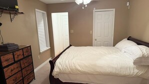 A bedroom with a bed, dresser, and a ceiling fan. - 2-bedroom house in wonderful Demopolis with cool AC (Demopolis)