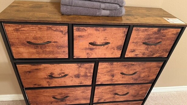 A wooden chest of drawers with six drawers and black handles. - 2-bedroom house in wonderful Demopolis with cool AC (Demopolis)