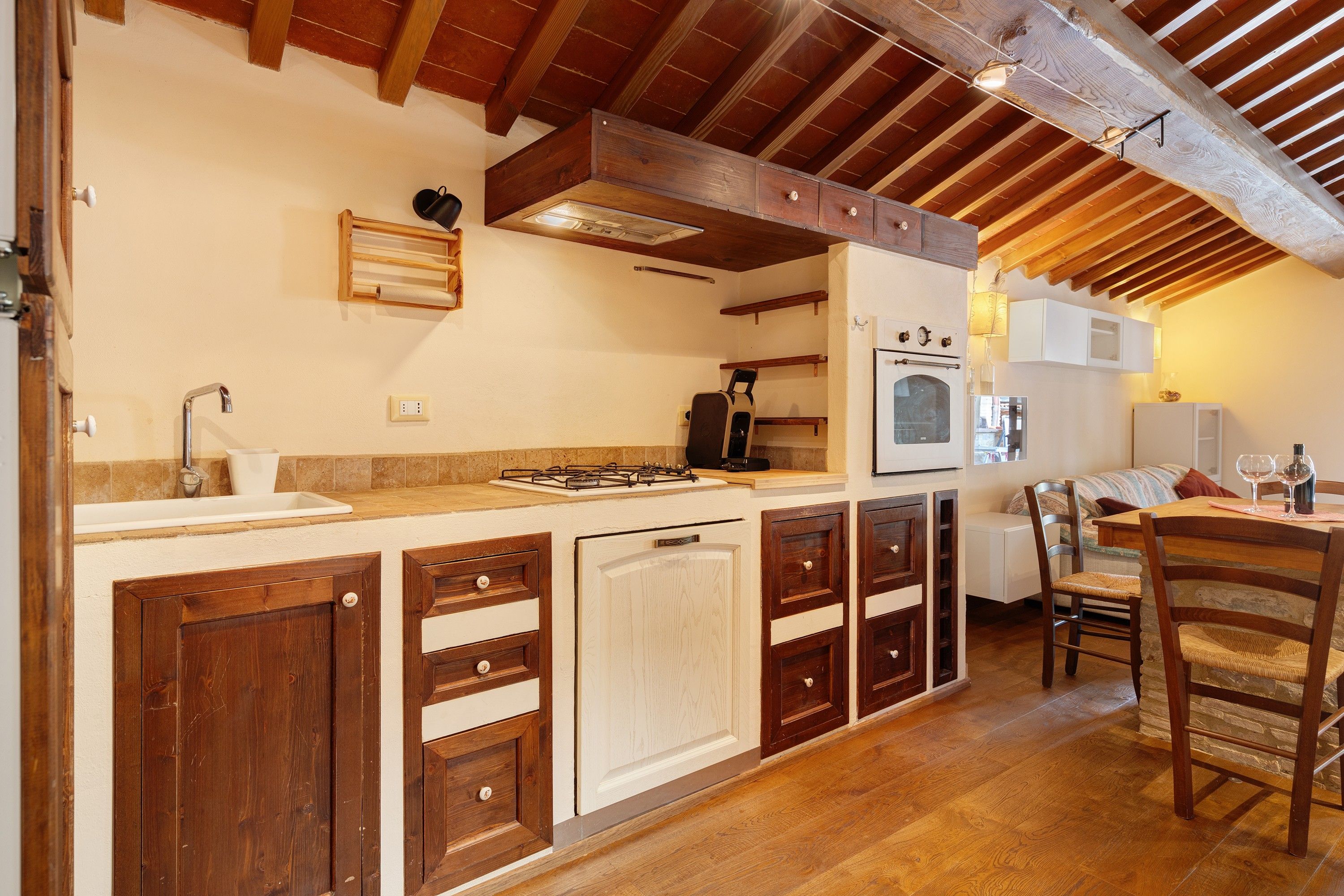 A kitchen with wooden cabinets, a gas stove, and a built-in oven.