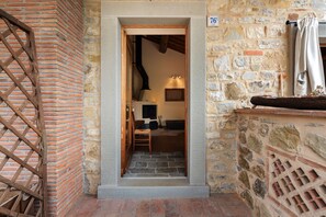 A stone building entrance with a wooden door, a brick wall, and a stone staircase leading inside. - Green Deluxe Casa De Fiori – Agriturismo with Experiences, Breakfast Included - Le Ceregne Bio (Pieve Santo Stefano)