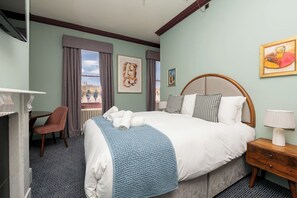A hotel room with a large bed, a desk, a chair, and artwork on the walls. - Super central room in the heart of Bath - Pass the Keys (Bath)