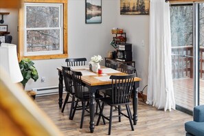 Enjoy meals together at the cozy dining table, perfectly situated by the windows and just steps from the deck for easy outdoor access. ️ - Cece's Chalet: Hot Tub * New Owner Offer (Mount Jackson)