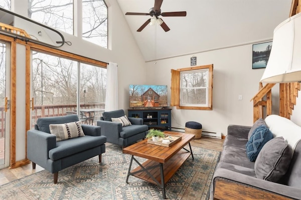 Gather and relax in the bright, airy living room flooded with natural light and a large Roku smart TV.