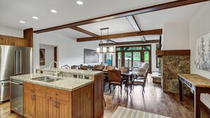 A spacious kitchen with granite countertops, wooden cabinets, and a large island. - Platinum 3BR Beaver Creek Condo | Ski-in/Ski-out (Avon)