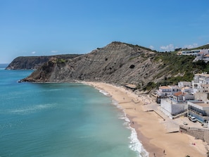 A coastal town with a beach, rocky cliffs, and buildings along the shore. - Dappan Bleu Apartment, Burgau, Algarve (Burgau)