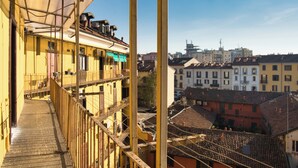 A high-rise building with balconies and a view of the cityscape. - Cozy Navigli Loft - One Bedroom Apartment, Sleeps 2 (Milano)