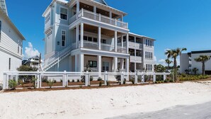 A multi-story beachfront house with balconies, a covered porch, and a sandy beach in the foreground. - Gulf Views | Private Pool | LSV | Elevator (Santa Rosa Beach)