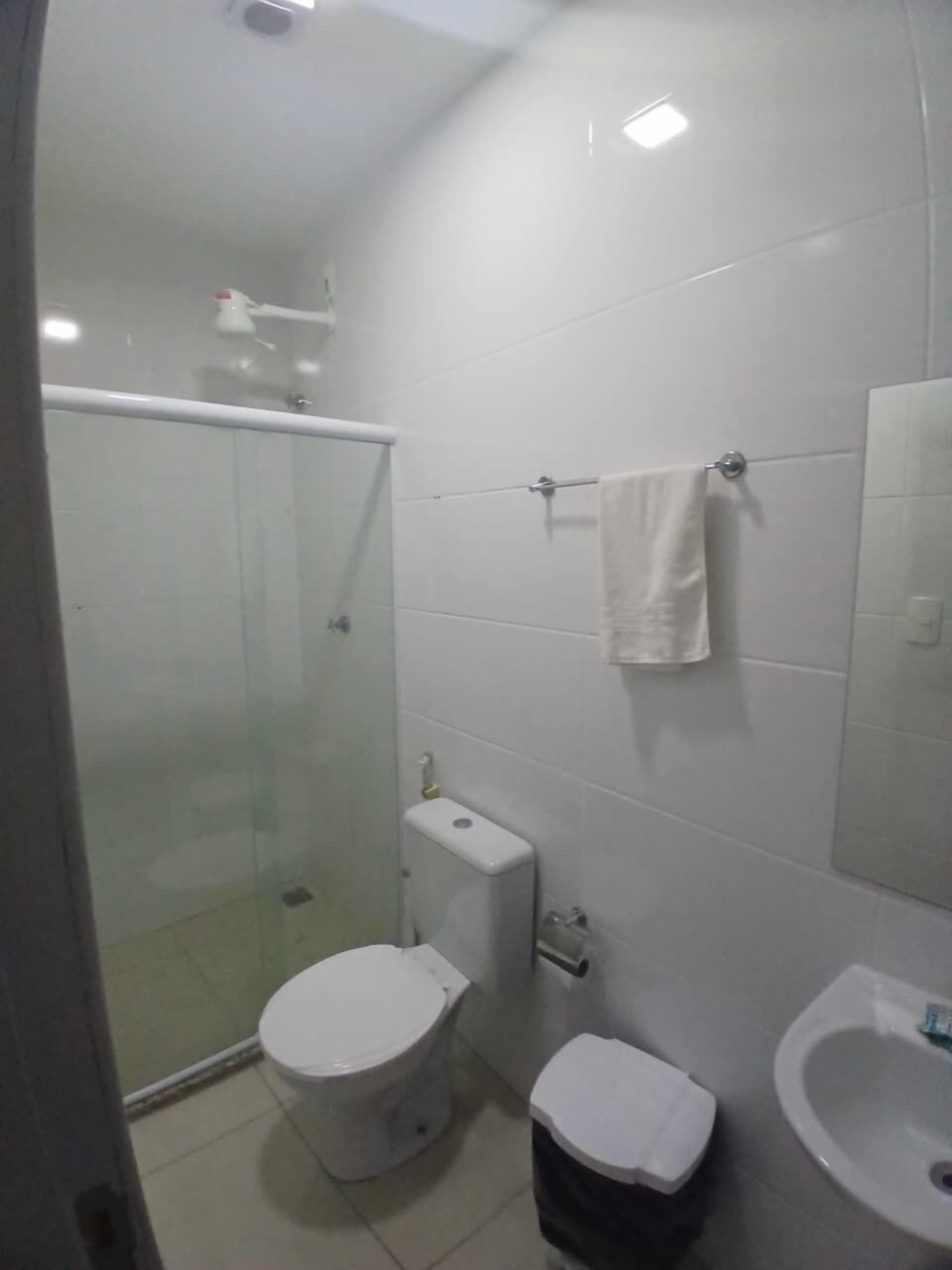 A bathroom with a toilet, bidet, and sink.