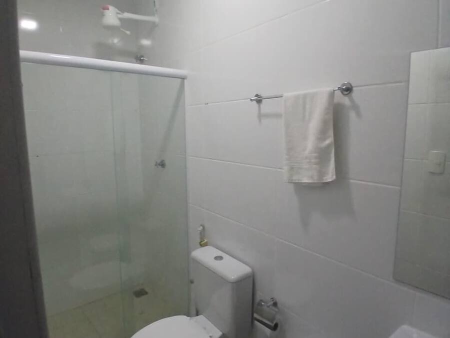 A bathroom with a toilet, bidet, and sink.