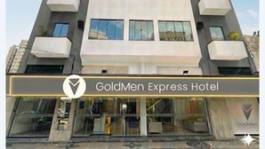 A modern hotel building with a flat facade, multiple balconies, and a prominent entrance with glass doors. - GoldMen Express Campos dos Goytacazes (Campos)