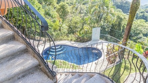 A staircase leading to a pool surrounded by lush greenery. -  Casa Nubes (Puerto Carrillo)