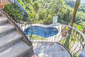 A staircase leading to a pool surrounded by lush greenery. -  Casa Nubes (Puerto Carrillo)