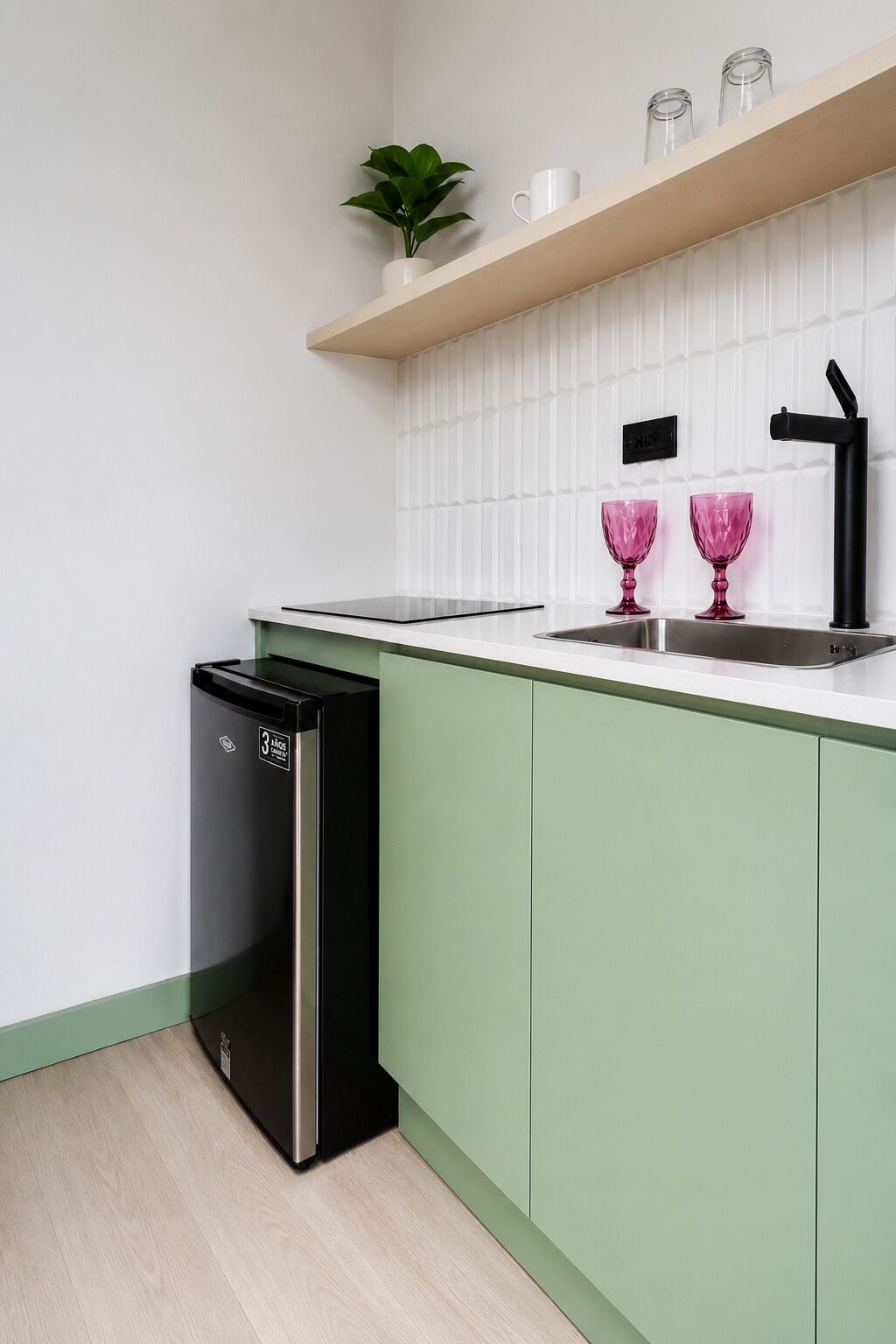 A kitchen with a dishwasher, a sink with a faucet, and a shelf with a plant and glasses.