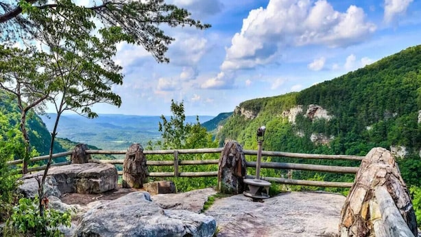 A rocky outdoor area with a wooden fence, large boulders, and a bench. - A-Frame w/ VIEWS | Walk to Downtown/Park | Pets OK (Mentone)