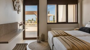 A hotel room with a bed, a seating area with a bench, a small table with a vase, and a view of the outdoors. - Villa Phoebeia, Wonderful Sea Views, Outdoor Infinity Pool, Antipata, Kefalonia (Kefalonia)