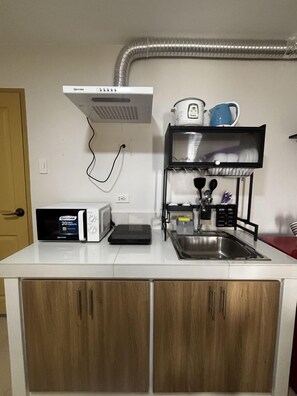 Fridge, microwave, stovetop, cookware/dishes/utensils - Warm & Welcoming 2BR Stay in the Heart of the City (Iloilo City)