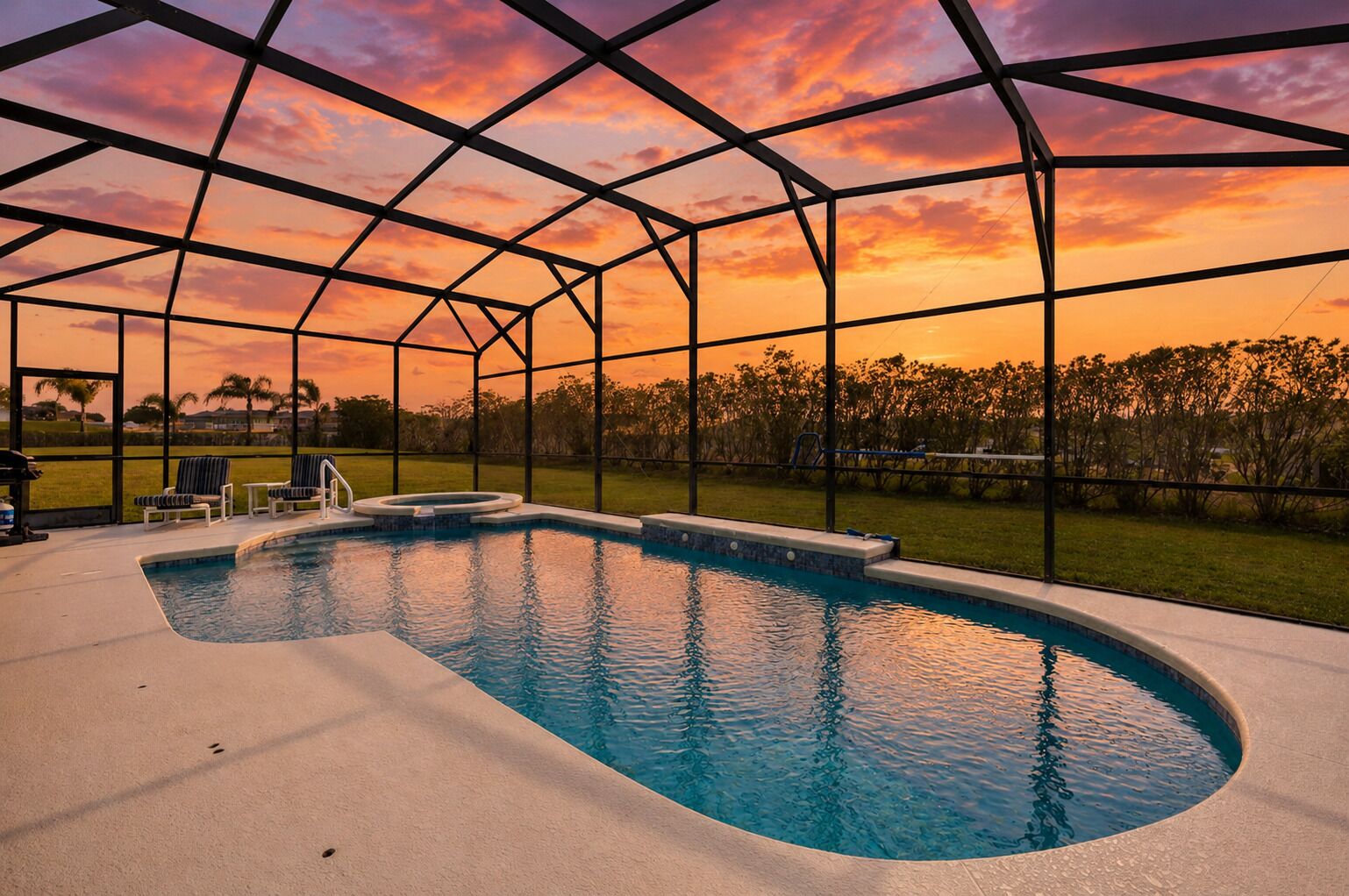 A swimming pool with a clear view of the sky and surrounding landscape.