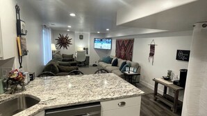 A modern kitchen with a granite countertop, stainless steel appliances, and a built-in dishwasher. - Guest Favorite, 5 Star Cozy 1-bedroom corporate apartment in perfect West Jordan (West Jordan)