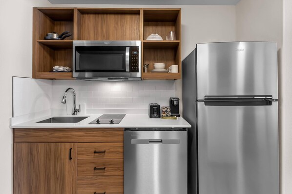 A modern kitchen with a stainless steel microwave, refrigerator, and dishwasher. - Everhome Suites Clarksville Ft. Campbell Area by Choice Hotels (Clarksville)