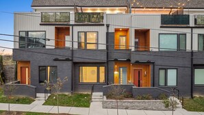 Un immeuble résidentiel moderne à plusieurs étages, doté d’un toit plat, de grandes fenêtres et d’une pelouse bien entretenue.