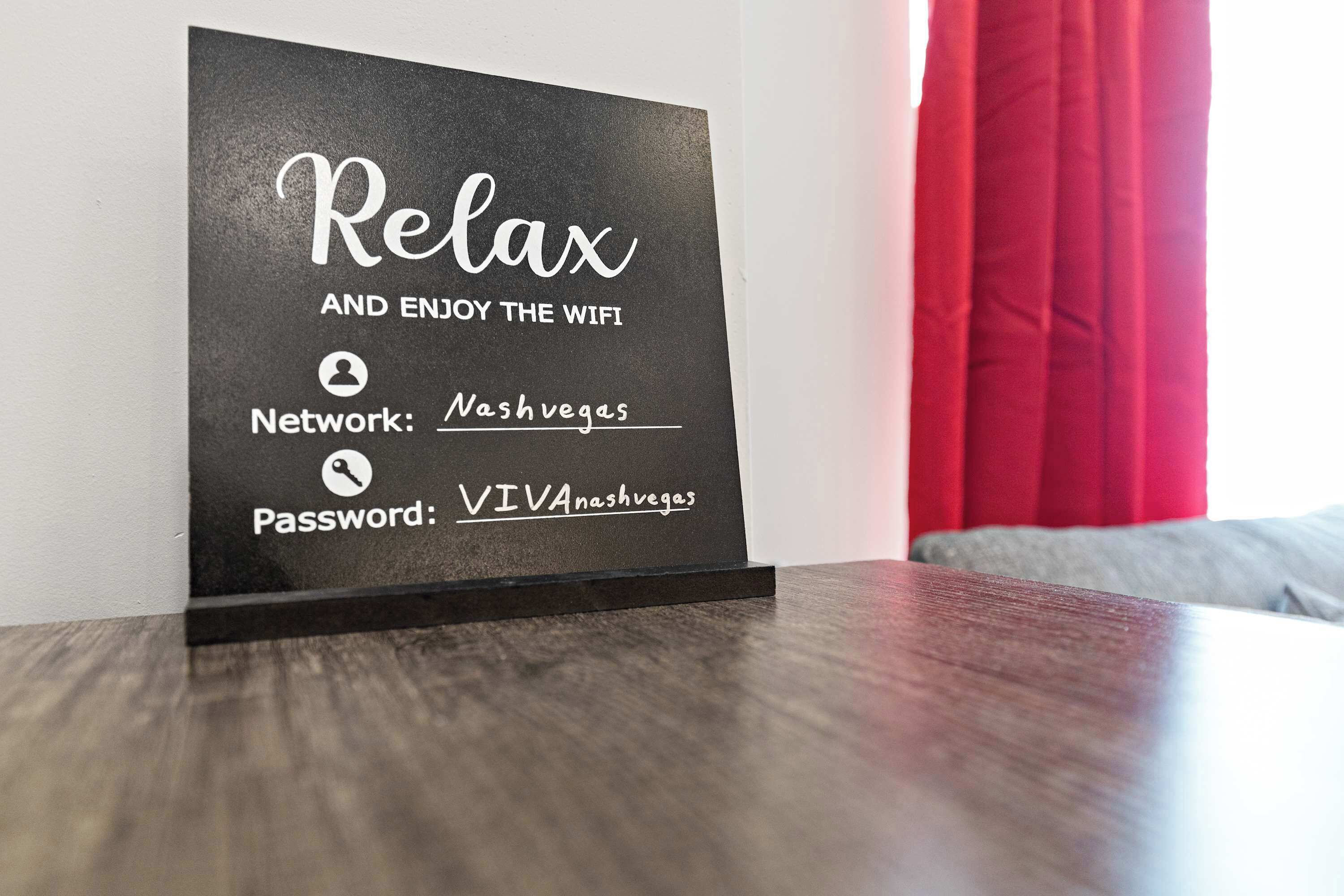 A sign with the text "Relax and enjoy the wifi" and network details for Nashvegas.