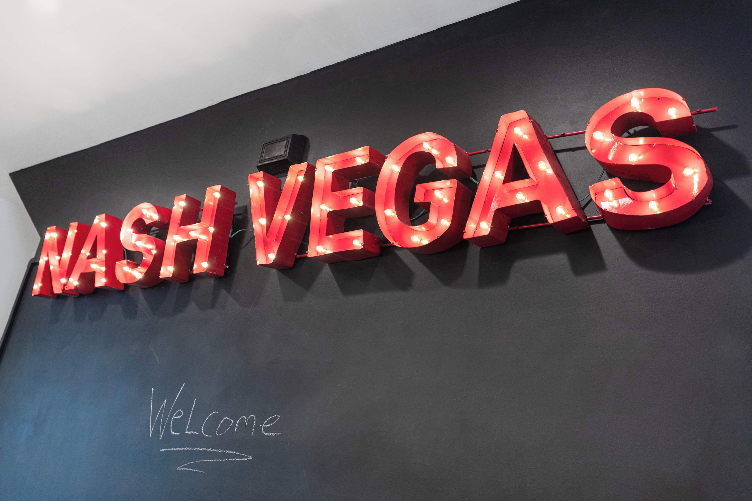 A large illuminated sign with the words "NASH VEGAS" in red letters against a dark background.