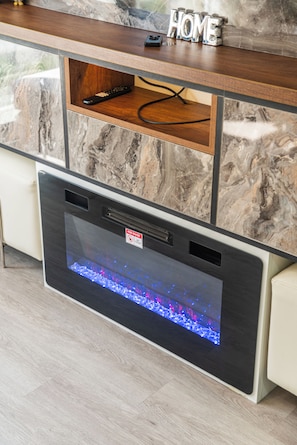 A modern kitchen with a built-in oven, a marble backsplash, and a wooden countertop. - Luxury apartment with a pool, ocean view, air conditioning, and a digital fireplace (Lima)