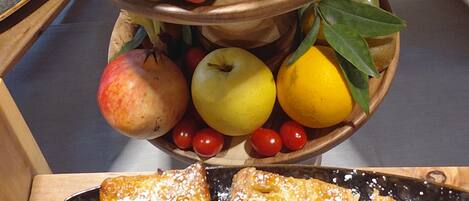 A fruit basket with apples, pears, bananas, and cherries.