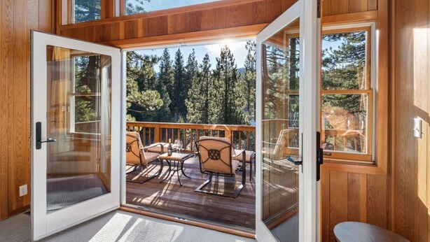 A wooden cabin with a deck, glass doors, and a view of trees. - Northstar Summer Hub | Hot Tub | MTB & Golf Access (Placer County)