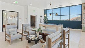A modern lobby with a pool table, comfortable seating, and large windows offering a view. - Views! Amenities! Pool/Spa/Gym/Bowl/Pking! (Salt Lake City)
