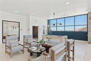 A modern lobby with a pool table, comfortable seating, and large windows offering a view. - Views! Amenities! Pool/Spa/Gym/Bowl/Pking! (Salt Lake City)