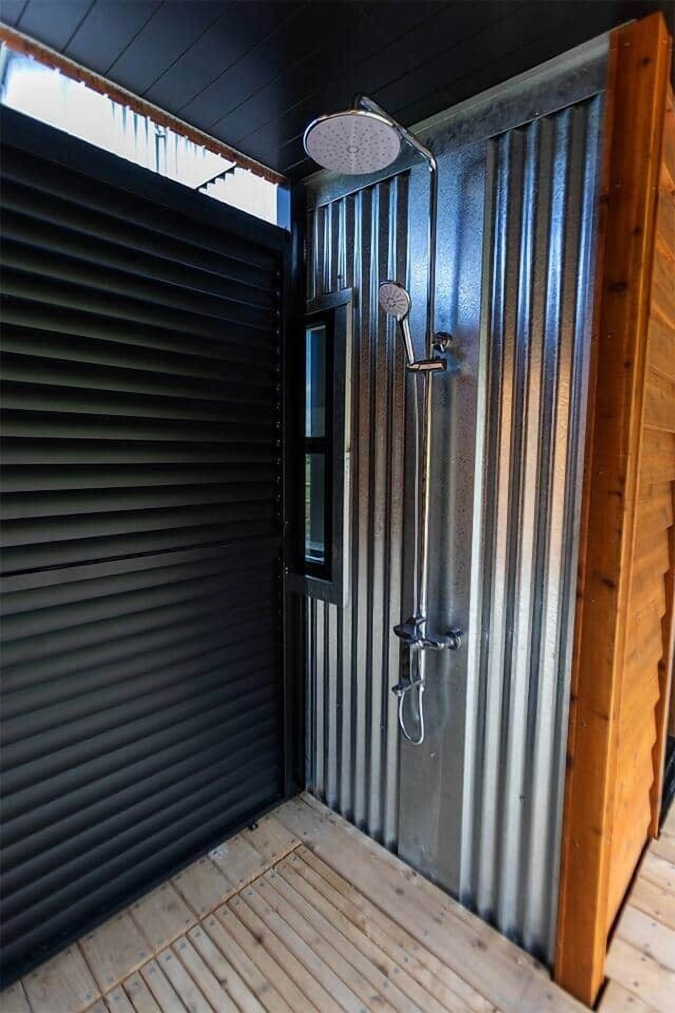 The outdoor shower runs both hot and cold.  The louvres tilt to provide privacy from the roadside if desired.