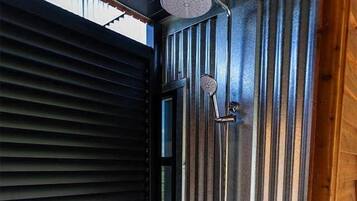 The outdoor shower runs both hot and cold. The louvres tilt to provide privacy from the roadside if desired.