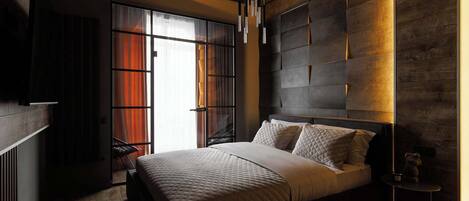 A modern bedroom with a large bed, a built-in headboard, and a skylight.