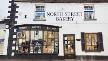 A white building with black trim and a sign reading "North Street Bakery."