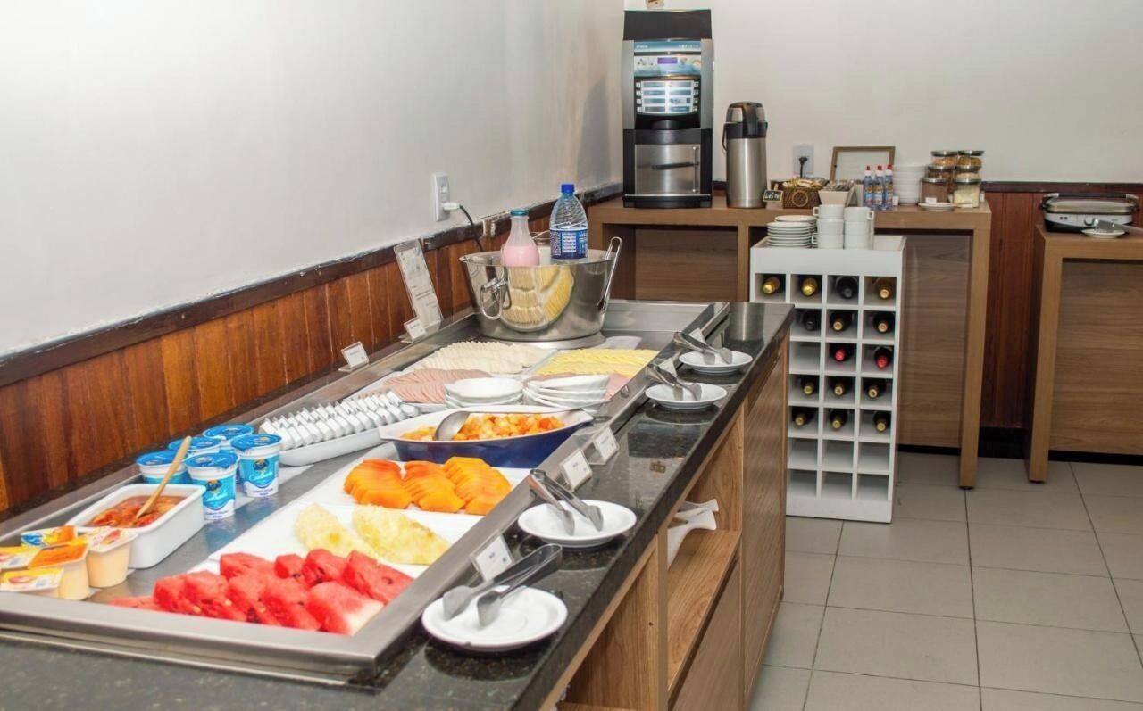 A buffet with various food items and a coffee machine.
