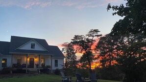 A house with a porch, outdoor seating, and a sunset view. - 3-bedroom home on quiet road with horse farms (Canton)