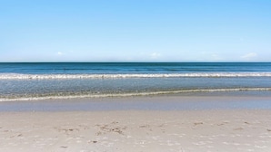 A beach with clear blue water and a sandy shore. - Beachfront w Stunning Views Modern Bright (Fort Myers Beach)