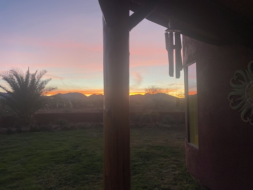 Secluded desert guest house with outdoor fireplace.