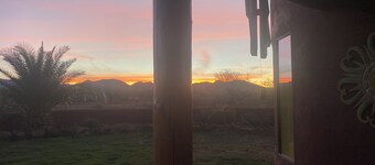 Secluded desert guest house with outdoor fireplace.