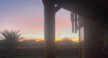 Secluded desert guest house with outdoor fireplace.