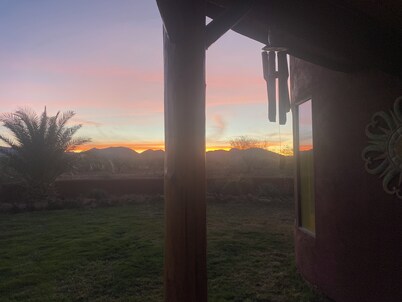 Secluded desert guest house with outdoor fireplace.