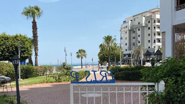 A gated entrance with a clear view of the beach and ocean in the background. - Cosy seaside apartment (Tanger)