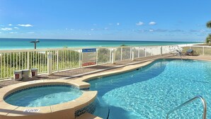 A swimming pool with a 'NO ENTRY' sign, a 'NO DIVING OR JUMPING' sign, and a view of the ocean. - Beachfront 1BR + Bunks Condo w/ Pools Sleeps 6! (Panama City Beach)