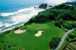 An aerial view of a golf course with two sand bunkers and a pathway leading to the tee area. - BERAWAHOUSE.com 5-19 Exclusive Designer Very Unique Berawa Beach MAX Fun+Style (Badung)