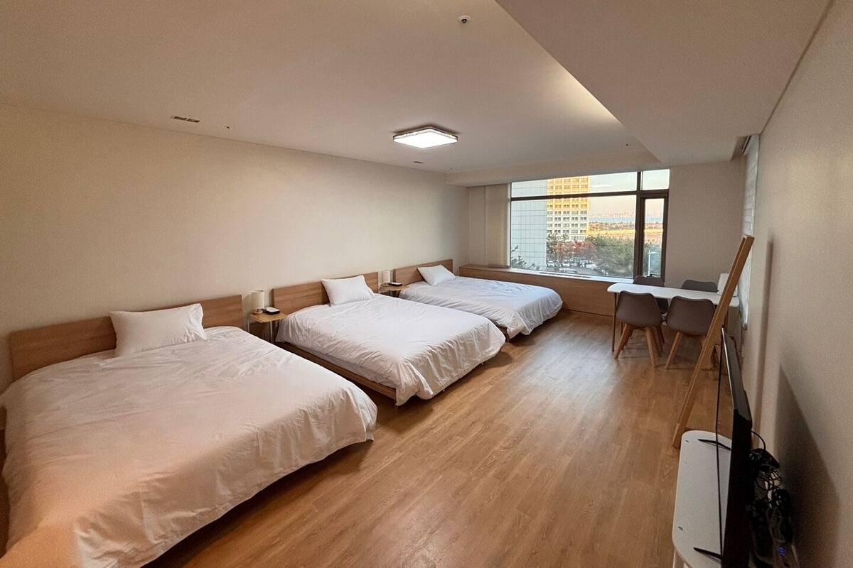 Family Triple Room, Partial Ocean View | Desk, laptop workspace, blackout drapes, free WiFi