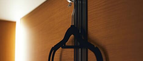 A wooden door with a metal hanger and a hook.